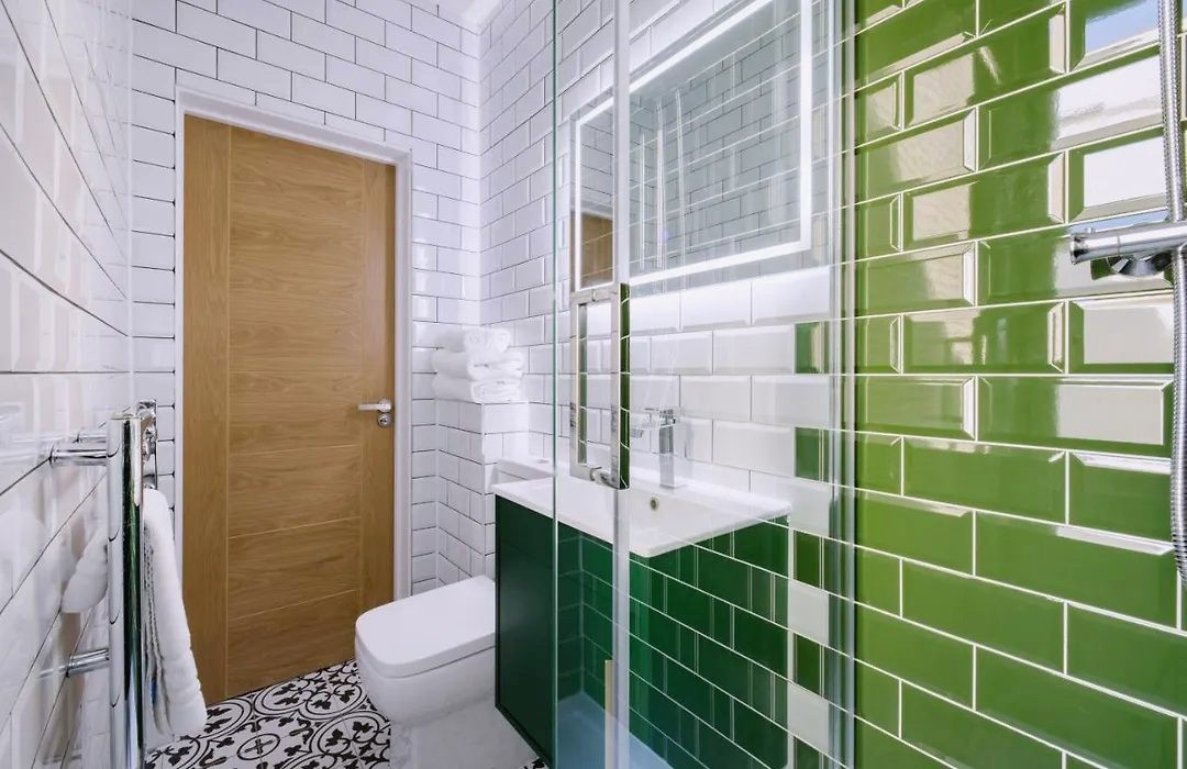 Bathroom with bottle-green metro tiles