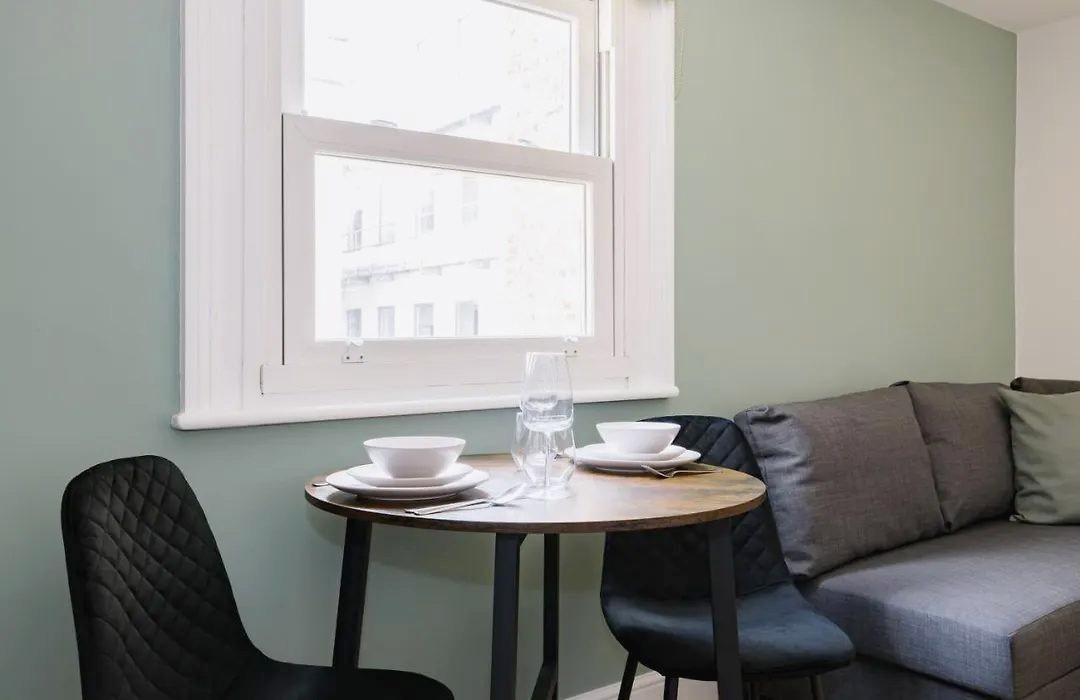 Round dining table by a sash window